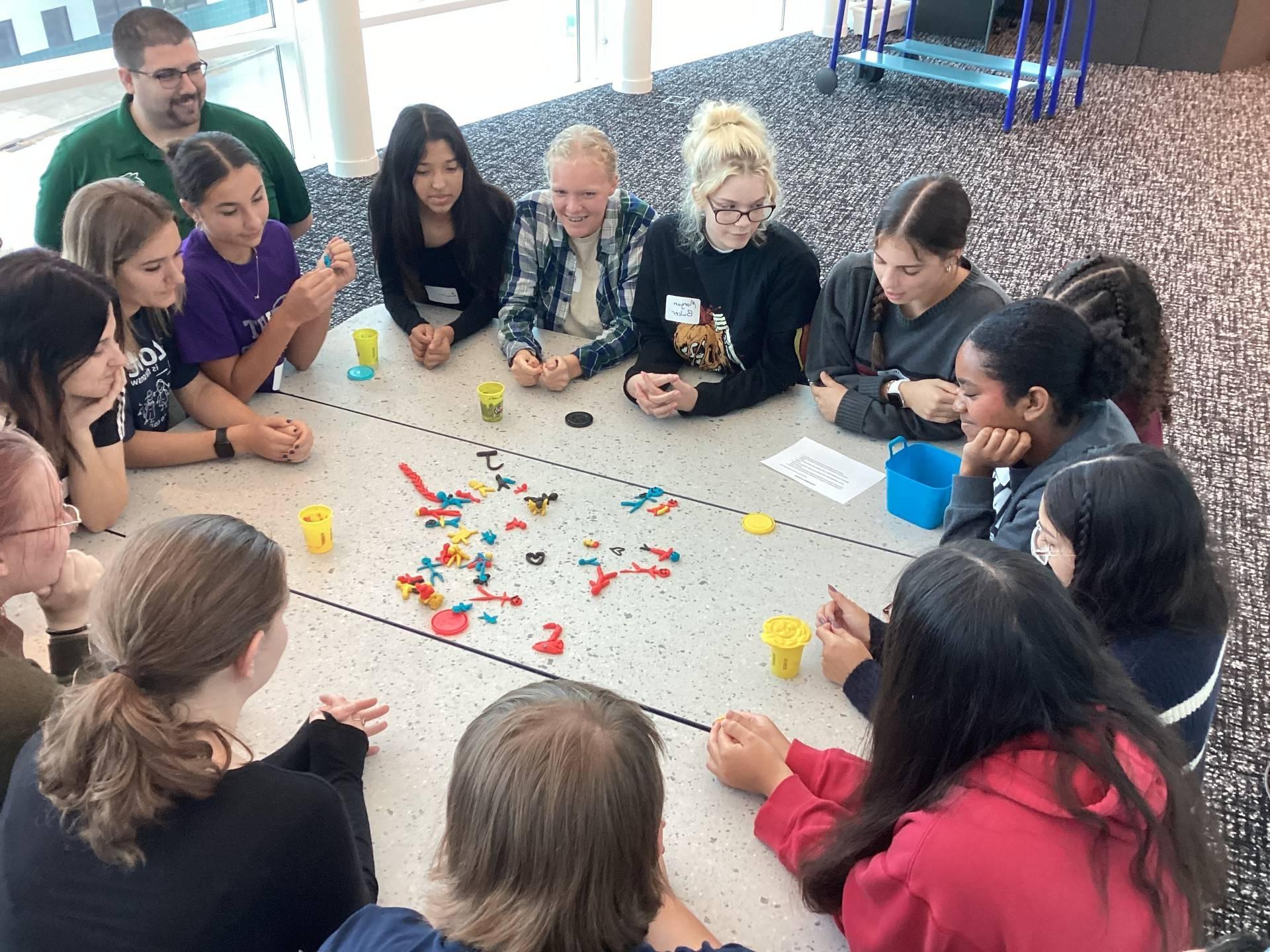 School students engage in group activity with Play-Doh